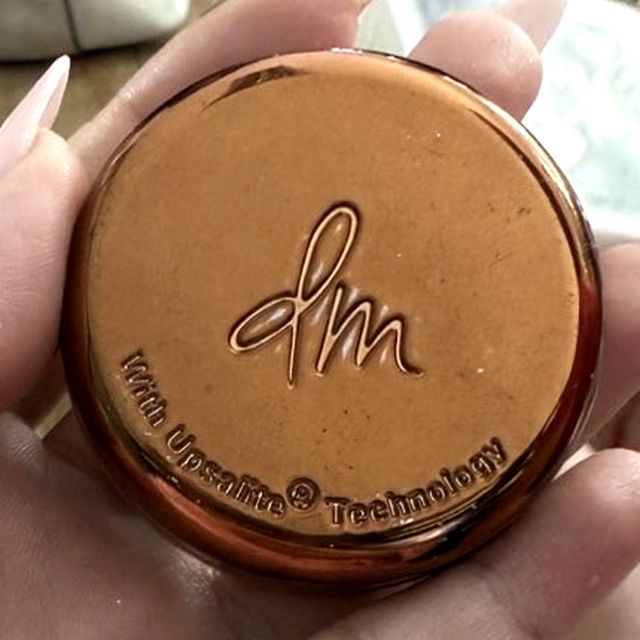 Danessa Myricks Yummy Skin Blurring Balm Powder jar with the dm logo