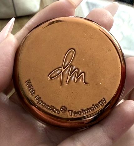 Danessa Myricks Yummy Skin Blurring Balm Powder jar with the dm logo