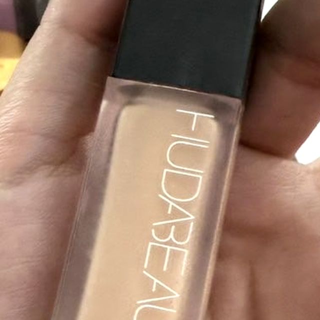 Huda Beauty #FauxFilter foundation bottle held in the hand