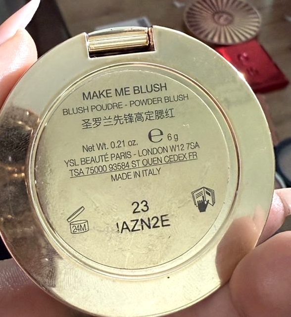 YSL Make Me Blush gold compact, base showing shade 23 and the batch code