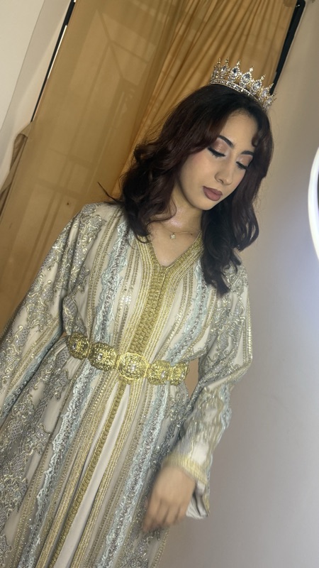 Bride in an embroidered caftan and crown with sculpted bronze eye makeup