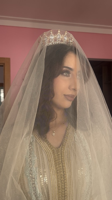 Moroccan bride in a gold takchita with a jewelled crown, wearing bridal makeup by Lamyaa Aissi in Casablanca