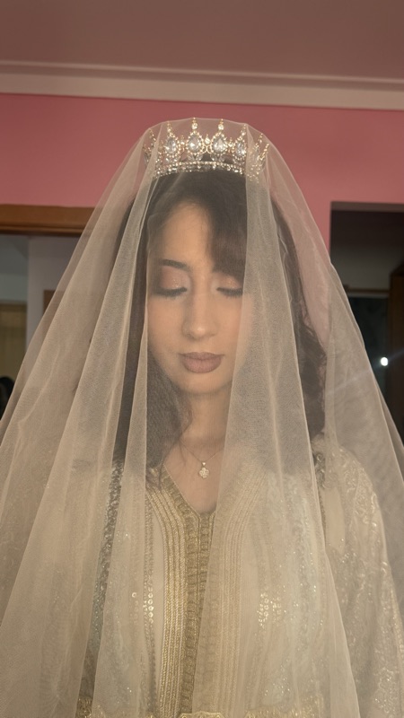 Moroccan bride under a veil with a crystal tiara and soft bridal makeup